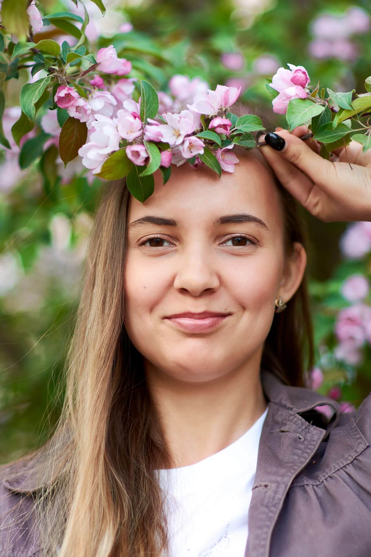 beautiful-young-woman-holds-a-branch-of-a-flowerin-2023-11-27-05-02-40-utc.jpg